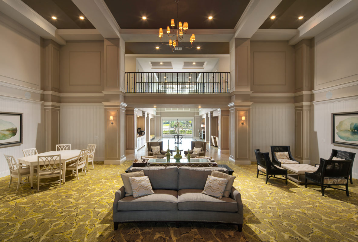 Interior of grand and spacious leasing lobby with comfortable seating and balcony