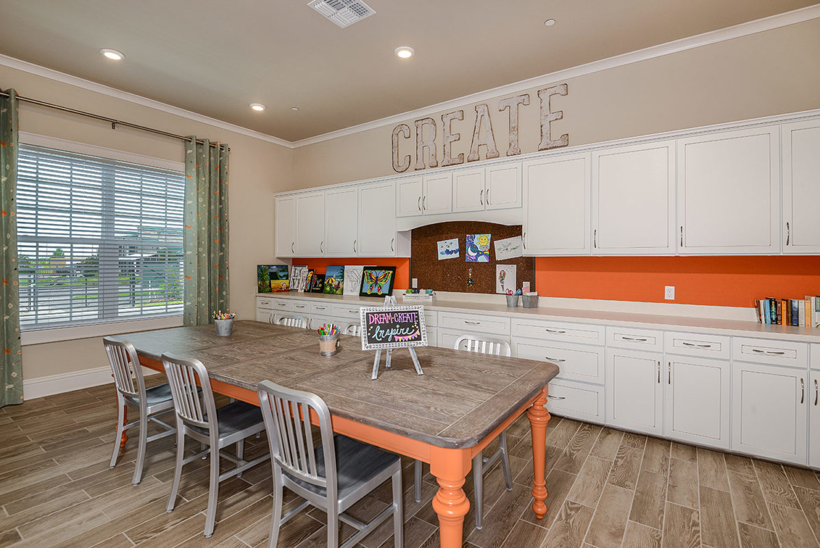 Craft room with supply cabinets and work tables