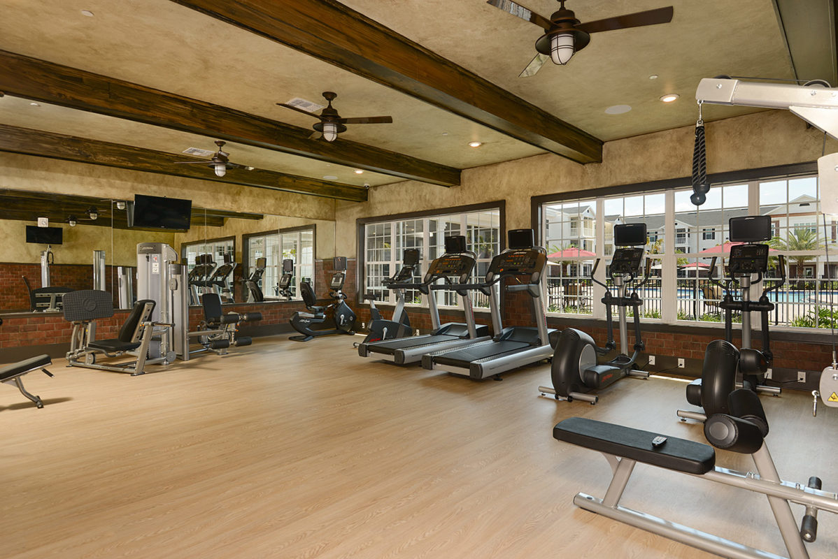Community fitness center with treadmills, cardio machines, free weights, and strength training machines