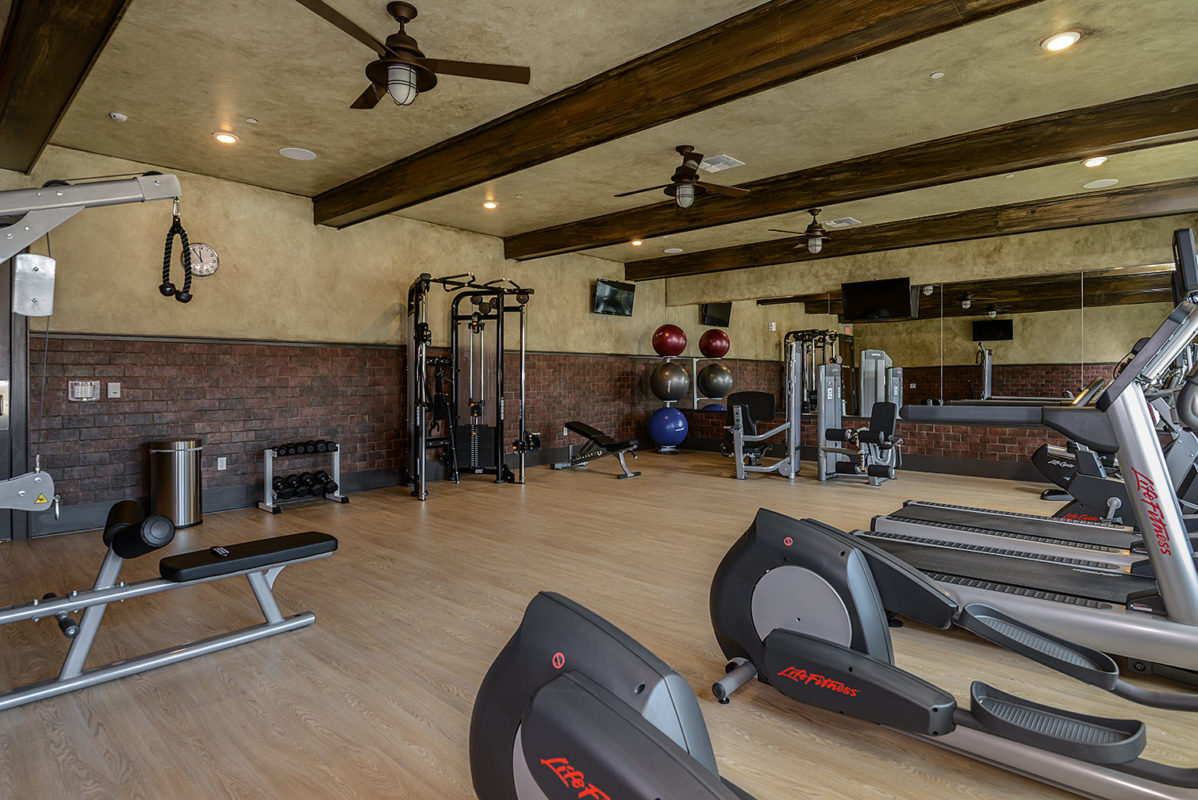 Community fitness center with ellipticals, cardio machines, free weights, and strength training machines